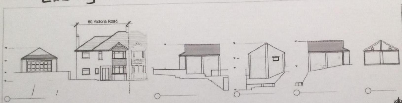 Architectural elevation drawings depicting a two-story house at 60 Victoria Road alongside multiple detached garages and outbuildings on a sloping site.