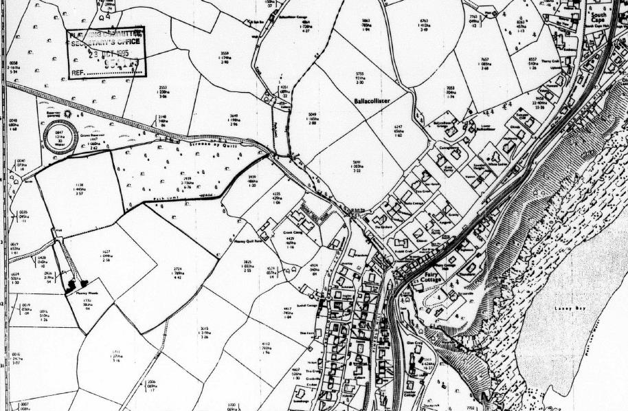 A black and white topographical map showing a rural coastal area with field boundaries, roads, and building footprints near Lonan Bay.