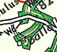 A cropped section of a site location map showing green land areas, white road lines, and partial text labels.