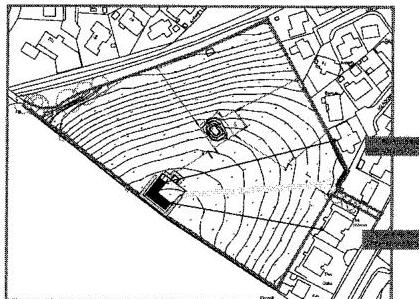 A black and white site plan showing a triangular plot of land with contour lines indicating topography and surrounding buildings.