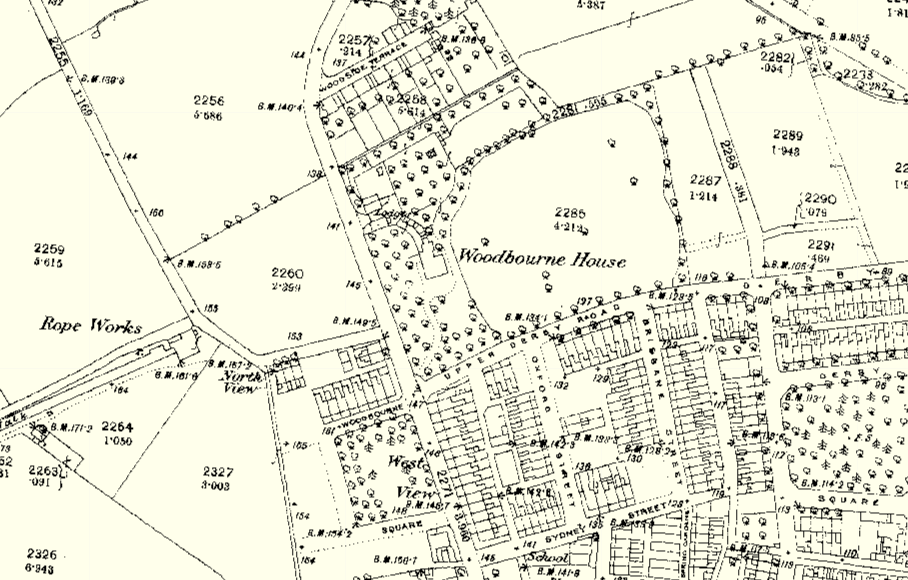 This image displays a historical site plan or OS map extract featuring 'Woodbourne House' and surrounding properties. It illustrates property boundaries, tree symbols, and road layouts in a rural context.
