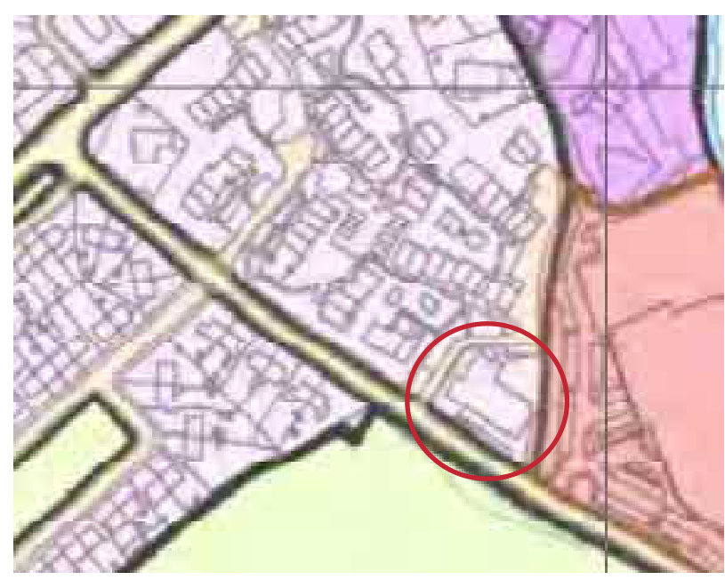 A zoomed-in section of a location map showing a specific property highlighted with a red circle, surrounded by other residential buildings and roads.