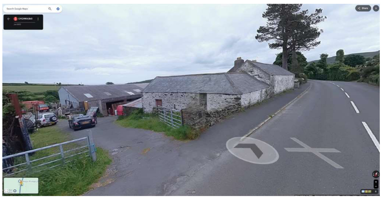 Google Street View screenshot showing existing stone barns and agricultural buildings alongside a rural road.