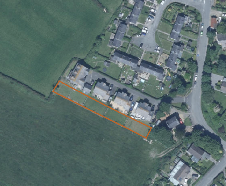 Aerial site plan showing a row of houses with an orange outline highlighting the rear garden and curtilage area.