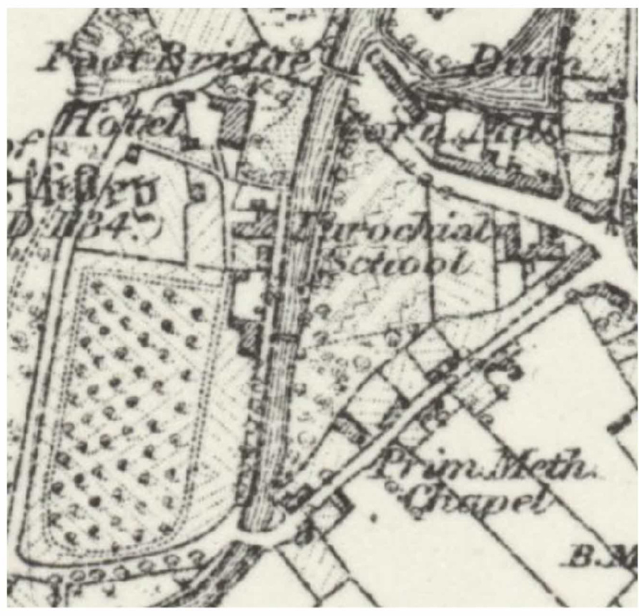 A historical black and white map showing local landmarks such as a hotel, parochial school, and chapel along with field boundaries and roads.