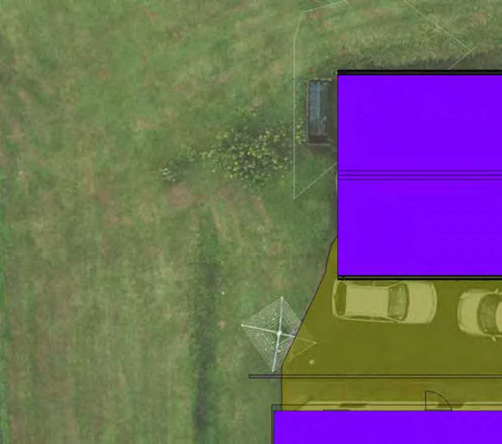 Aerial site plan showing proposed building footprints in purple and a driveway area in yellow overlaid on a grassy plot.