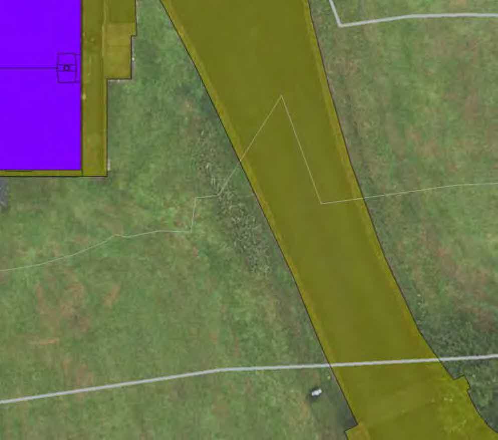 Aerial site plan showing a property boundary, a purple building footprint, and a yellow highlighted access driveway.