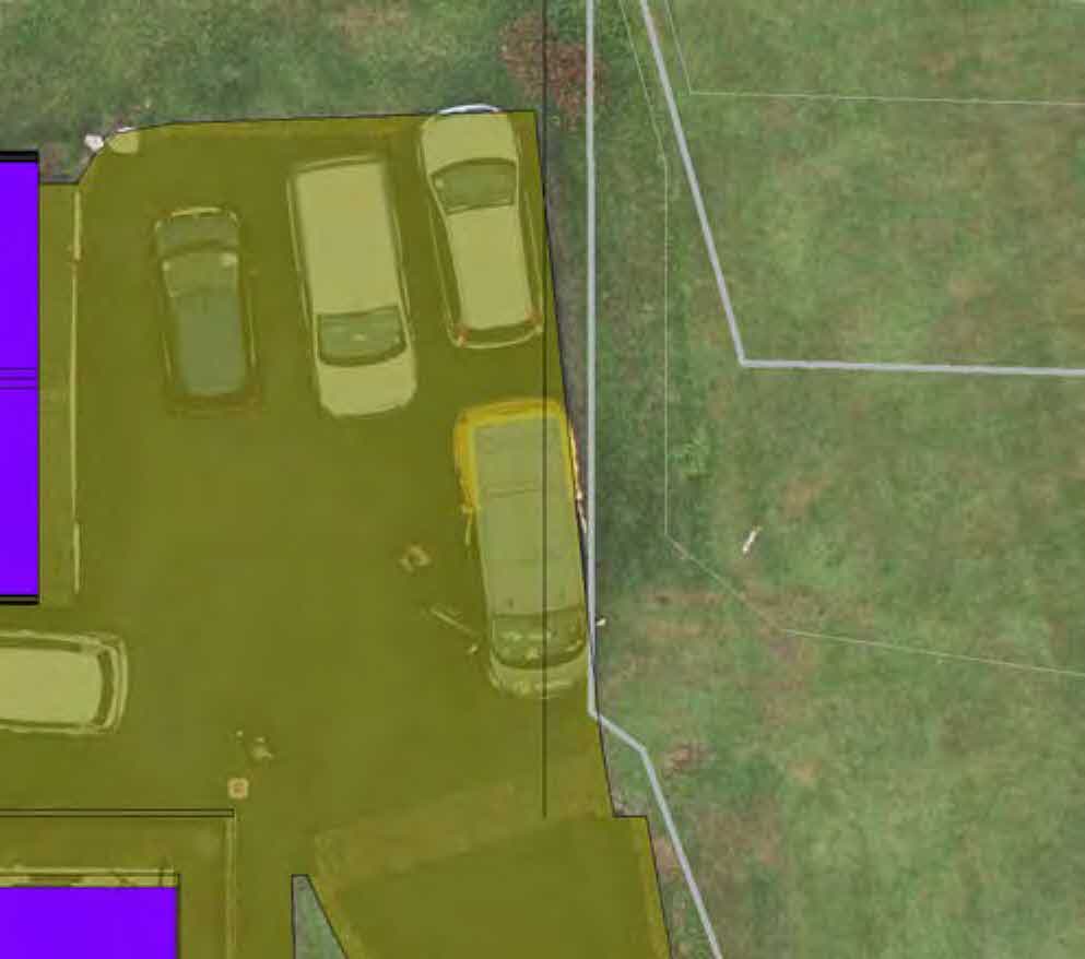 An aerial site plan showing a driveway with parked cars, property boundaries, and building footprints indicated by purple blocks.