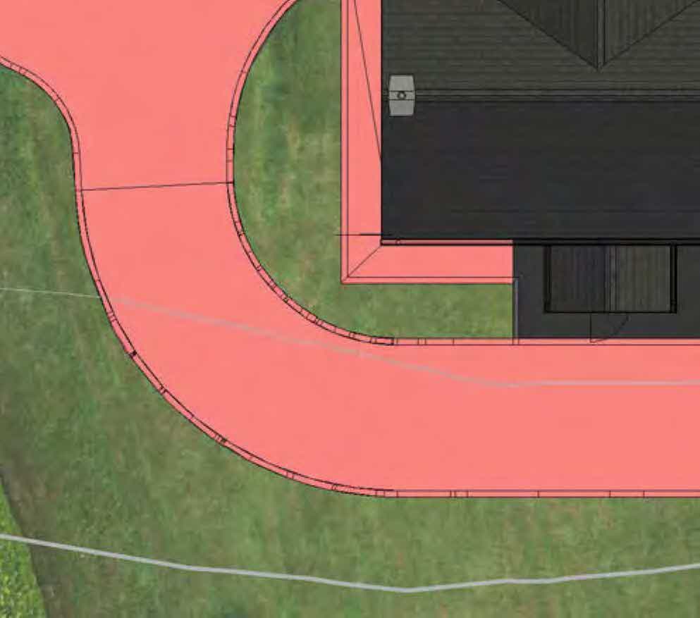 A top-down site plan detail showing a curved pink driveway, green lawn areas, and the corner of a building with dark roofing.