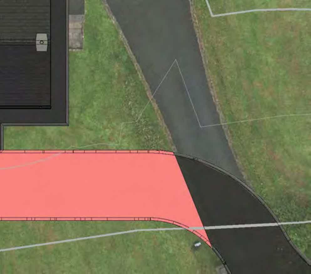 Aerial site plan view showing a proposed extension area highlighted in pink adjacent to an existing building and driveway.