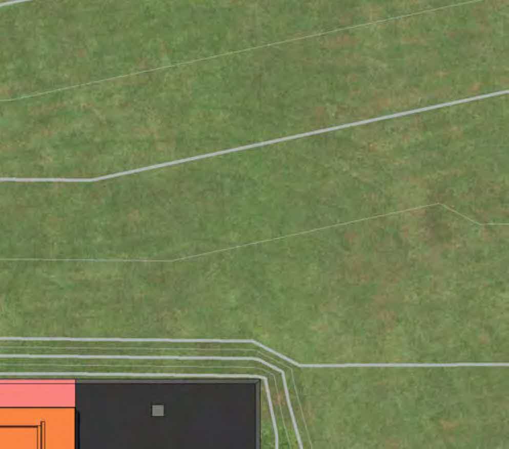 Aerial site plan view showing grassy land with white boundary lines and a partial building footprint in the bottom left corner.