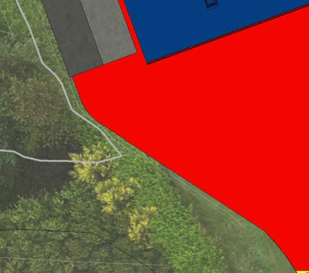 A site plan showing colored zones overlaid on an aerial photograph of a green, rural property.
