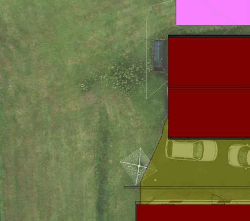 A top-down site plan showing a property layout with red building footprints, a yellow driveway with cars, and surrounding green land.