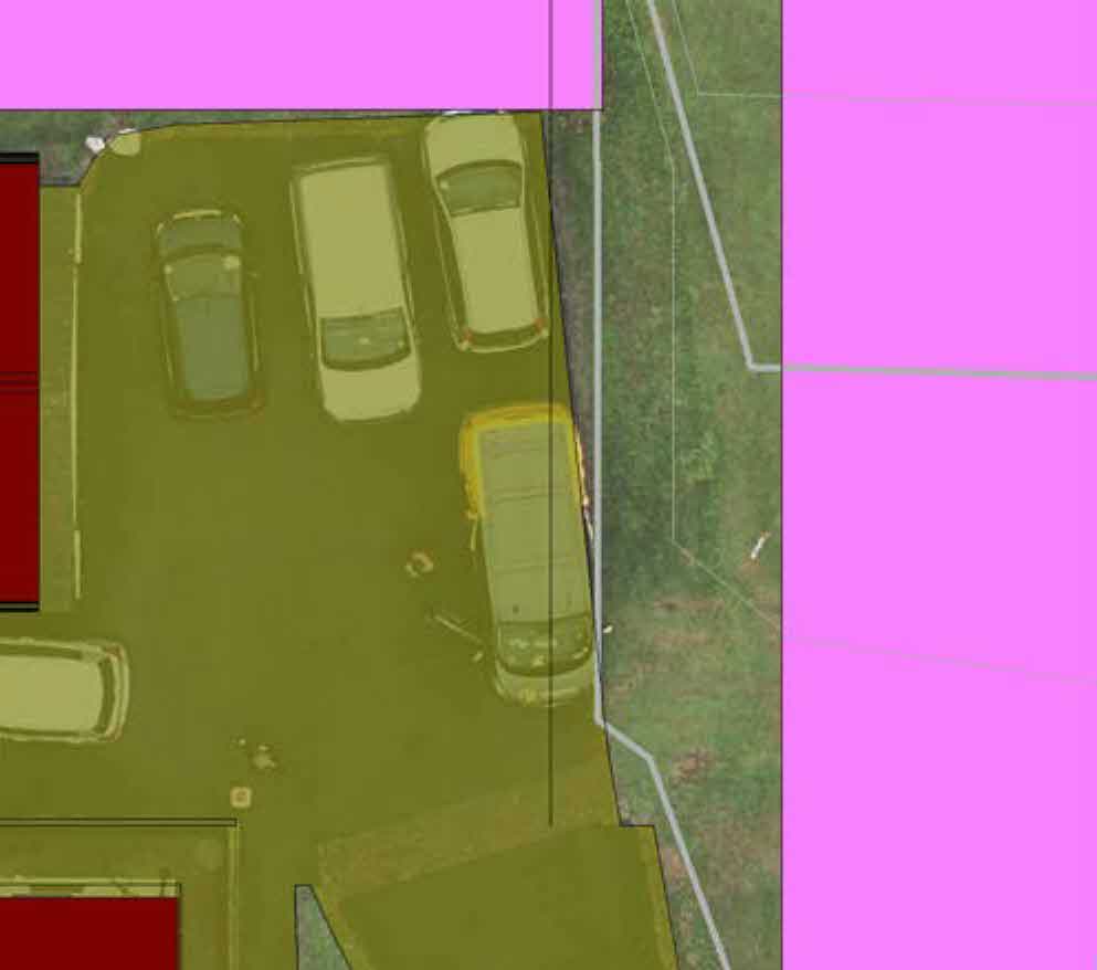 Aerial site plan showing a driveway with parked cars and property boundaries marked with colored overlays.