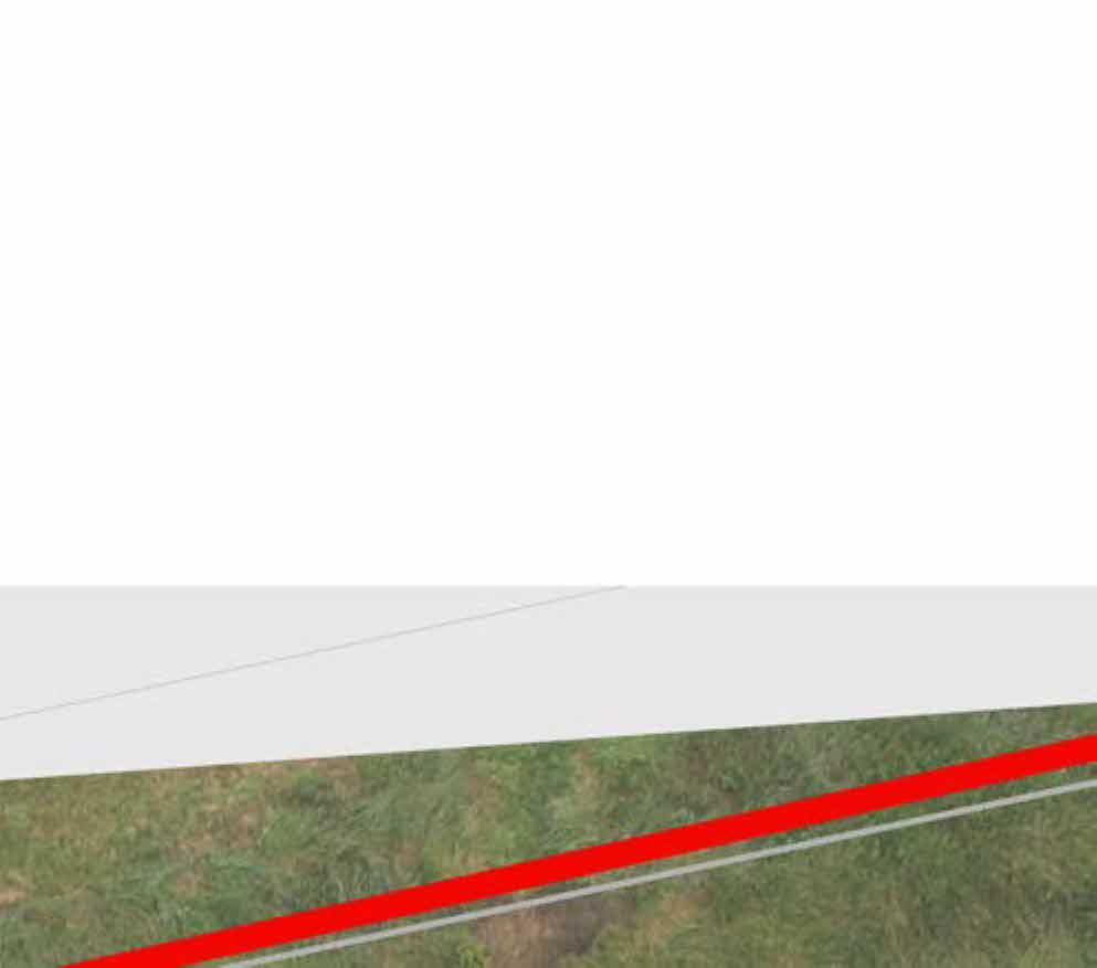 A cropped section of a site plan showing a road surface, grassy area, and a prominent red boundary line.