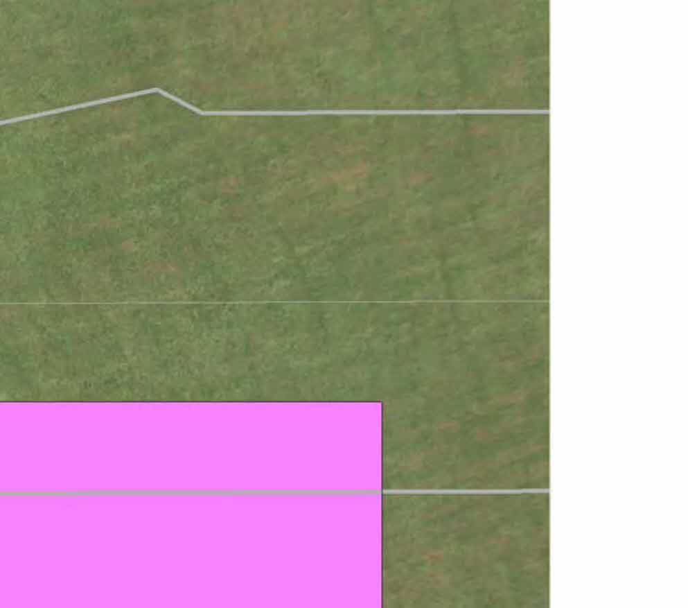 A cropped section of a site plan showing a grassy area with white boundary lines and a pink rectangular overlay indicating a proposed area.