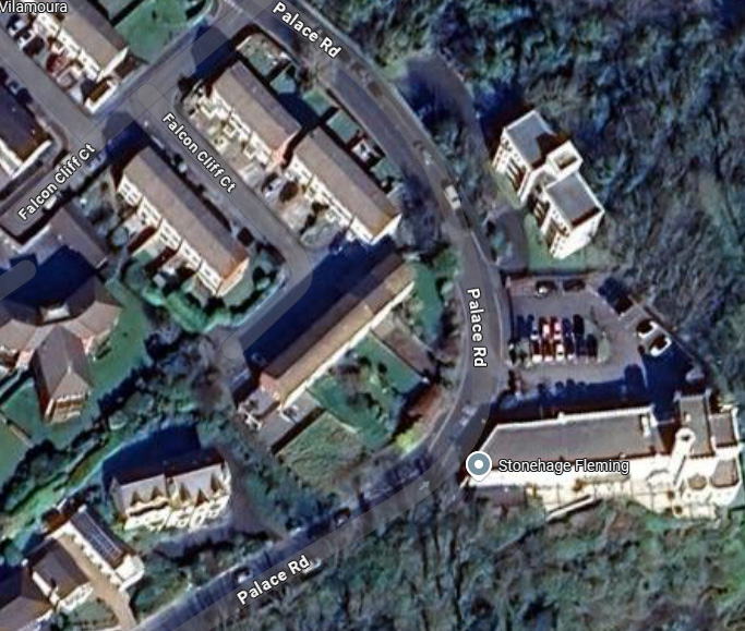 An aerial satellite view showing a residential area with roads labeled Palace Rd and Falcon Cliff Ct, featuring a location marker for Stonehage Fleming.