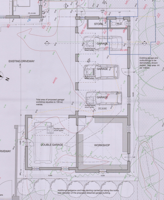 A technical floor plan showing the layout of a proposed double garage and workshop, including parking bays and storage areas, overlaid on site context.