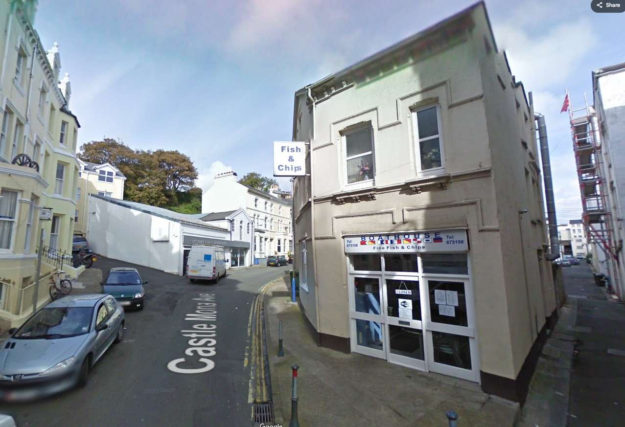 Street-level photograph showing a corner building on Castle Mews with a 'Boathouse Fish & Chips' shop on the ground floor and residential windows above.