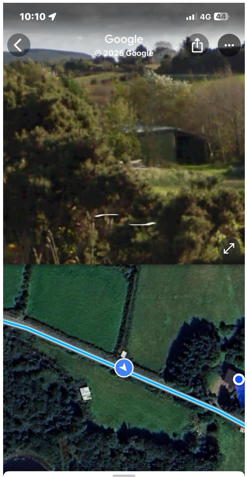 A mobile screenshot showing a split view of a rural site, combining a Google Street View of a building amidst trees with a satellite map view of the location and road access.