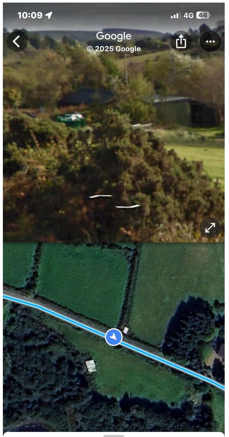 A mobile screenshot displaying a split-screen view of a rural site location, featuring a ground-level photo on top and an aerial map view below.