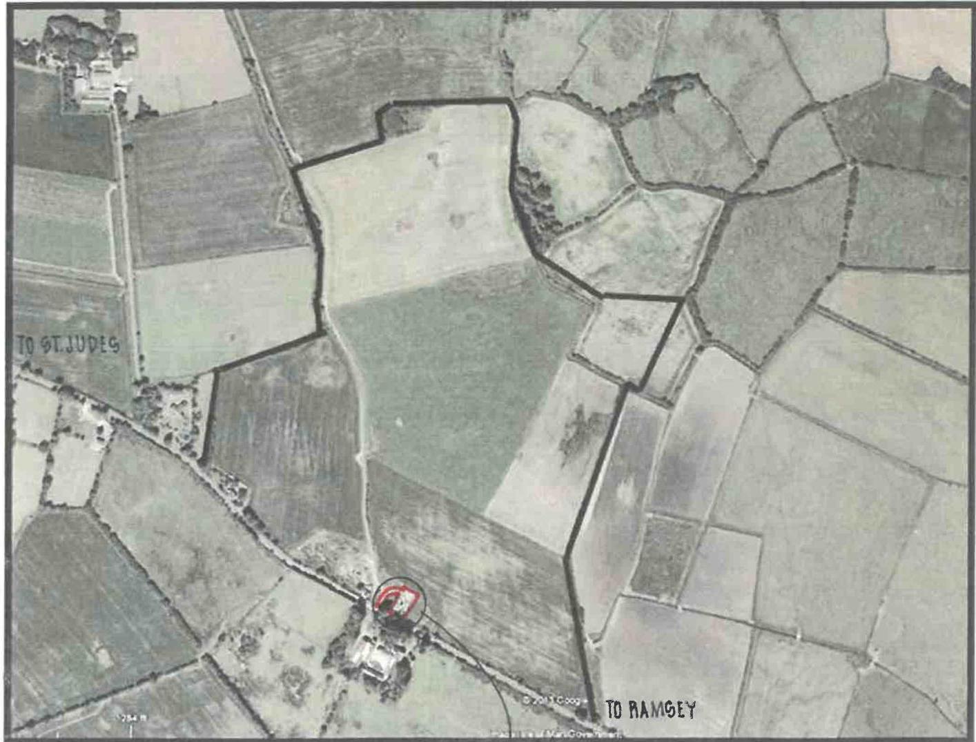 An aerial site plan showing a rural landscape with field boundaries outlined in black and a specific building highlighted in red.