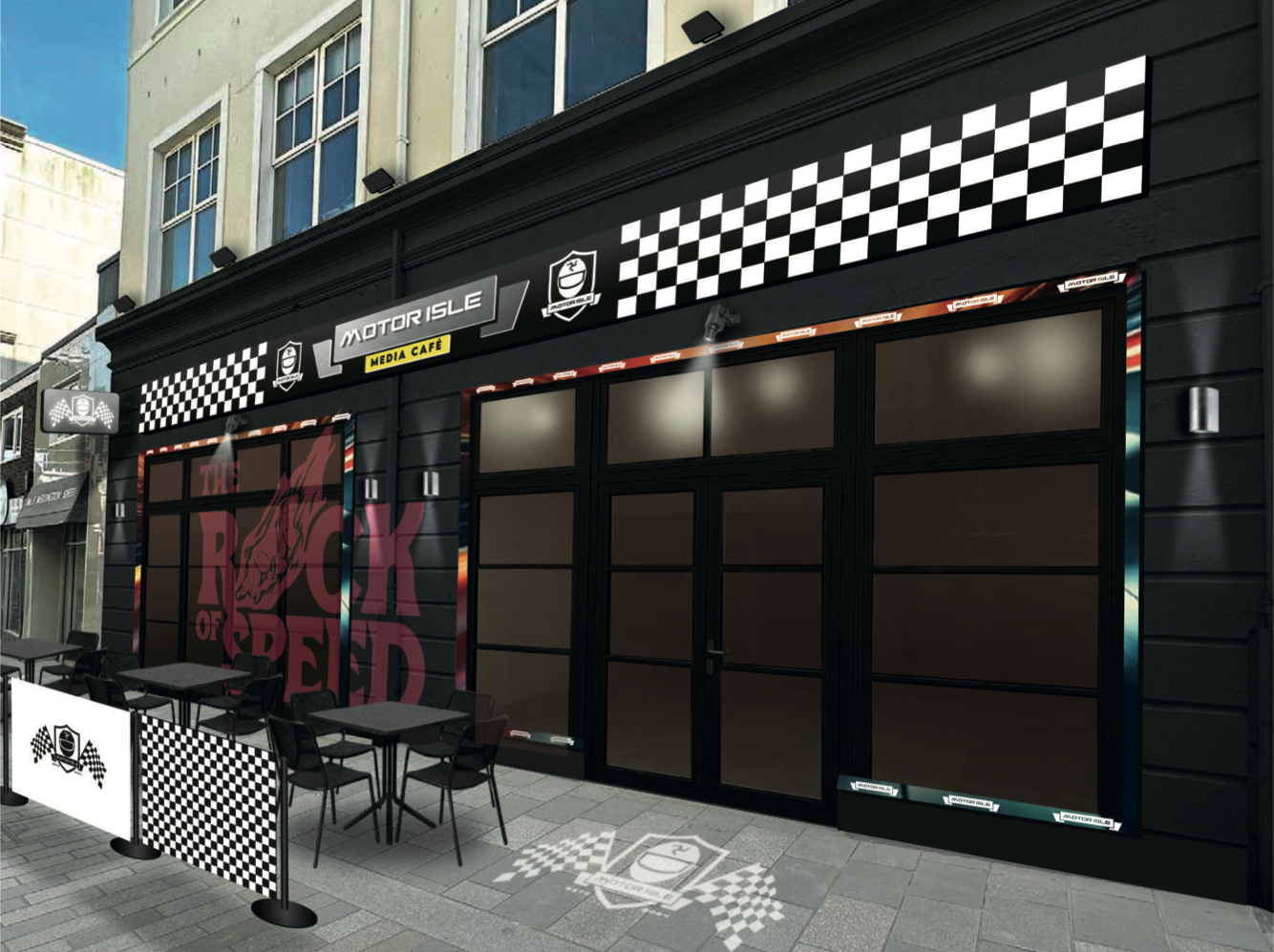A photorealistic rendering of the proposed front elevation for the Motor Isle Media Cafe, featuring black cladding, racing flag motifs, and outdoor seating.