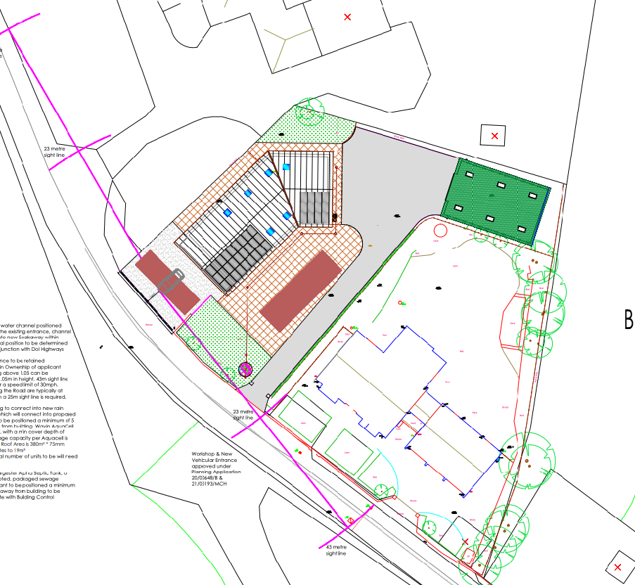 A technical site plan showing a workshop development with parking bays, vehicular access, drainage details, and landscaping features.
