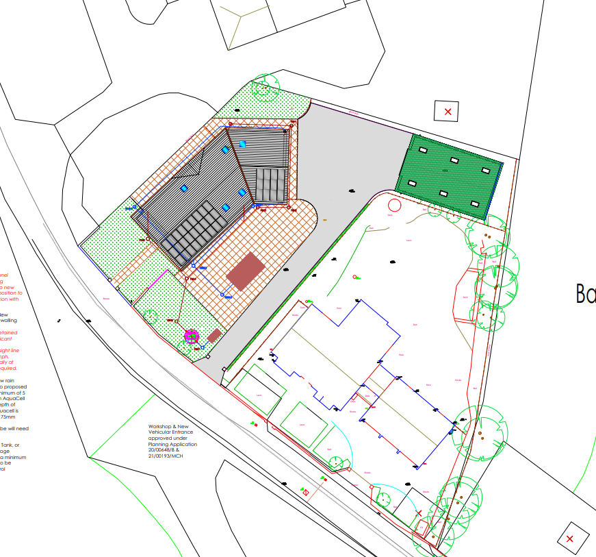 A technical site plan showing a workshop building footprint, paved driveway, and landscaping with trees.