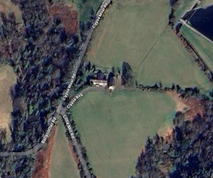 Aerial satellite view of a rural property at a road junction showing Clypse Moar Rd and surrounding fields.