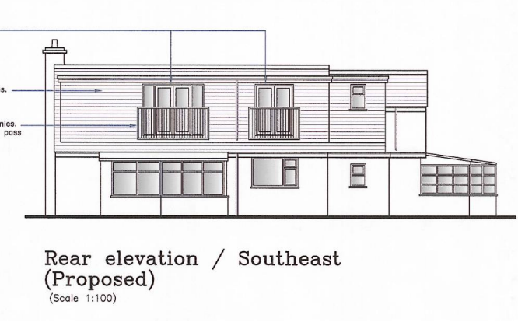 Architectural line drawing showing the proposed rear elevation of a two-storey building with a balcony and a lower single-storey section on the right.