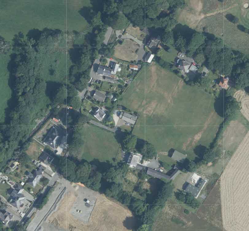 An aerial site location plan with grid lines showing a rural property surrounded by fields and trees.