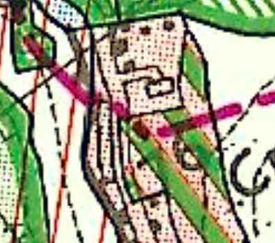 A close-up section of a site plan showing building footprints, property boundaries, and land features marked with colored lines and hatching.