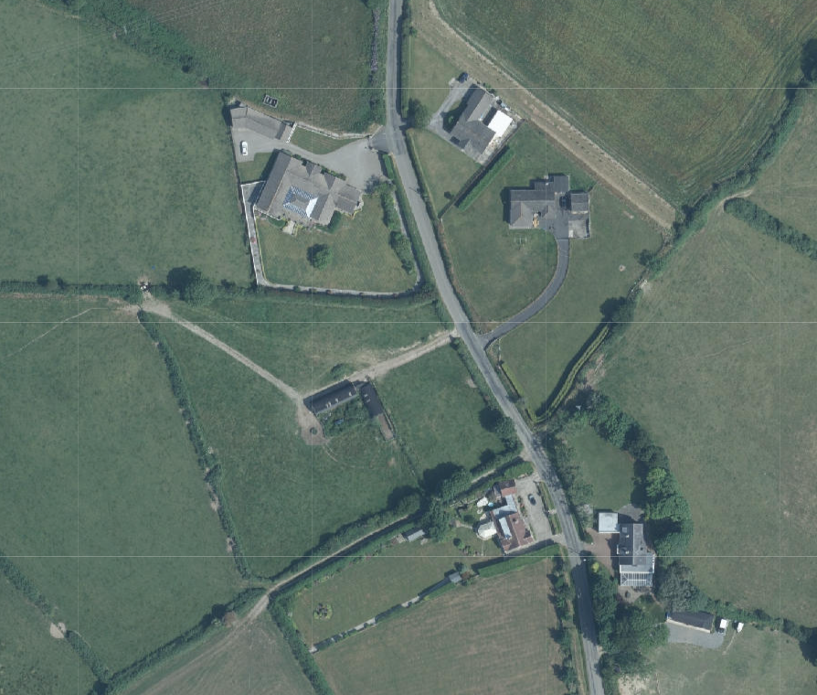 Aerial site location map showing a rural property with existing buildings, driveways, and surrounding agricultural fields.