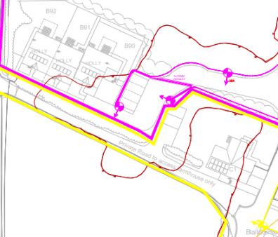 A technical site plan showing building footprints labeled B00-B02 and highlighted boundary lines in pink and yellow.
