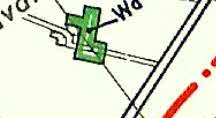 A zoomed-in detail from a site plan showing a green building footprint with boundary lines and partial text labels.