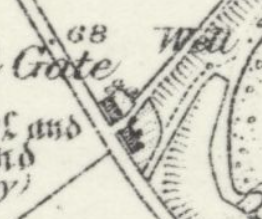 A close-up view of a vintage site plan or map showing property boundaries, a gate, a well, and small structures.